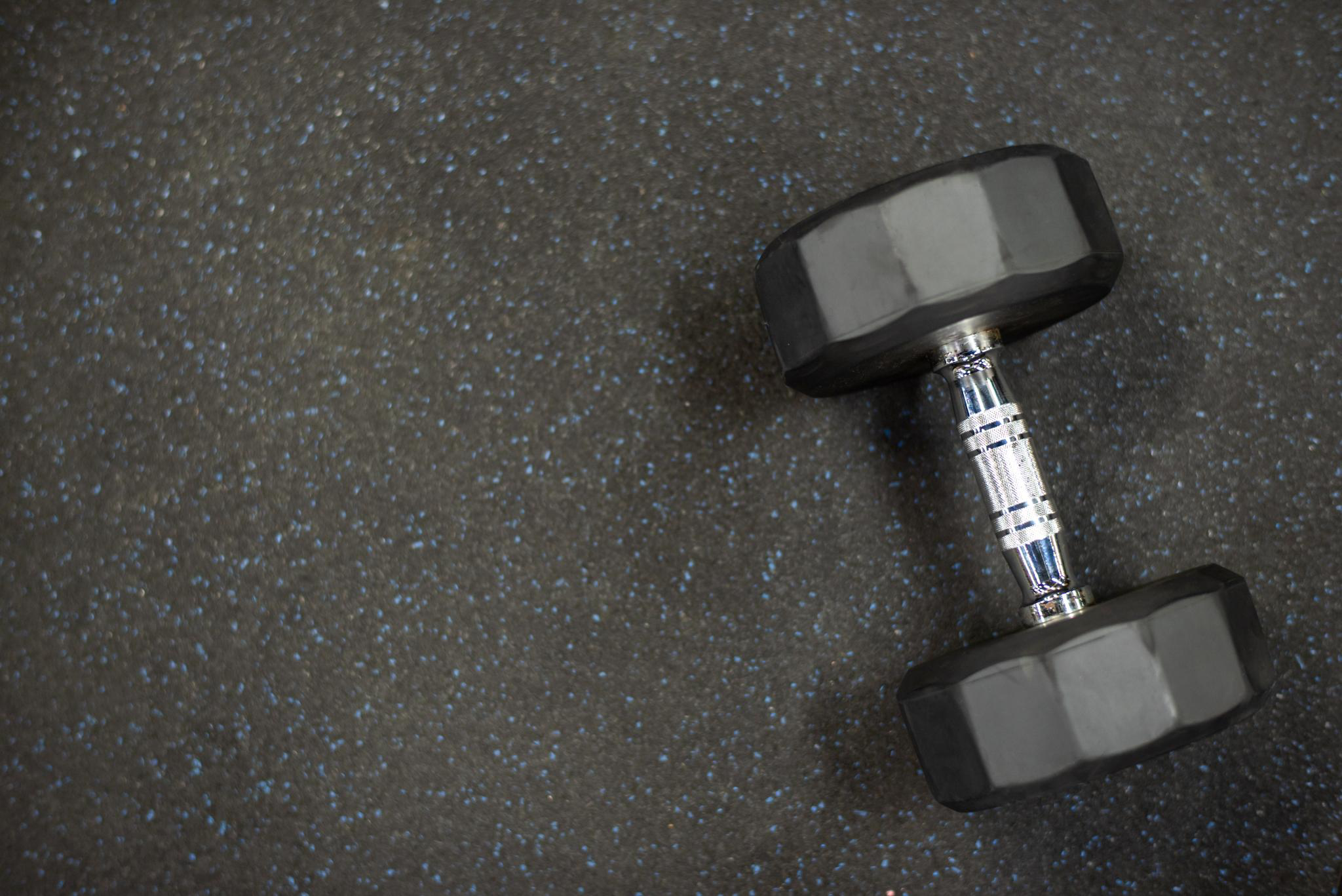 Rubber athletic flooring with dumbbell