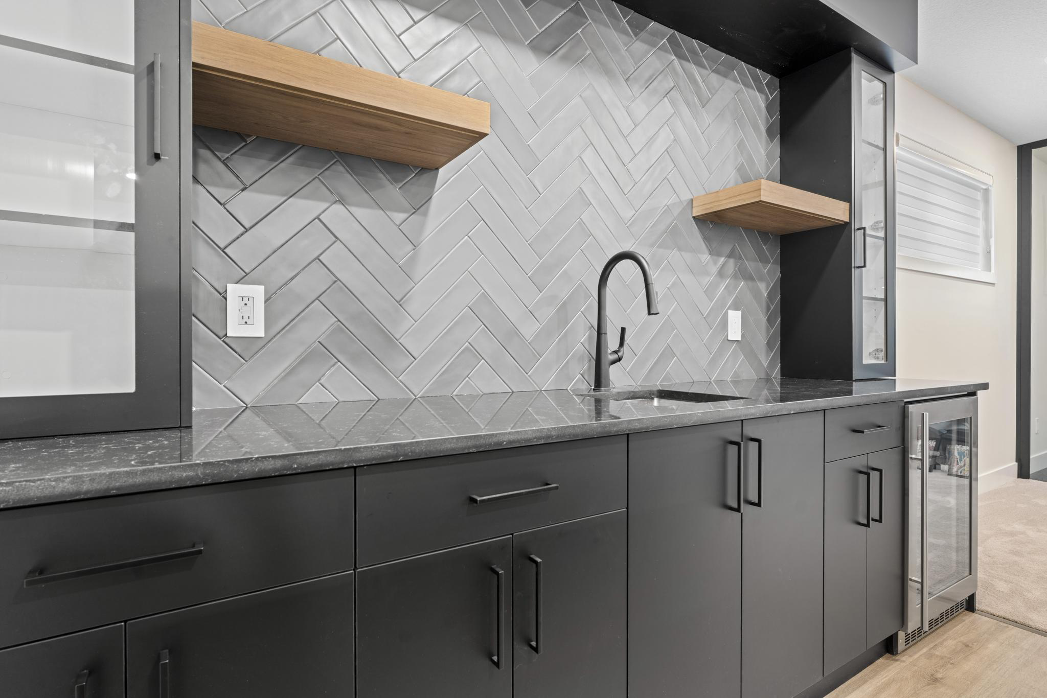 Stone and mosaic tile installation with herringbone pattern